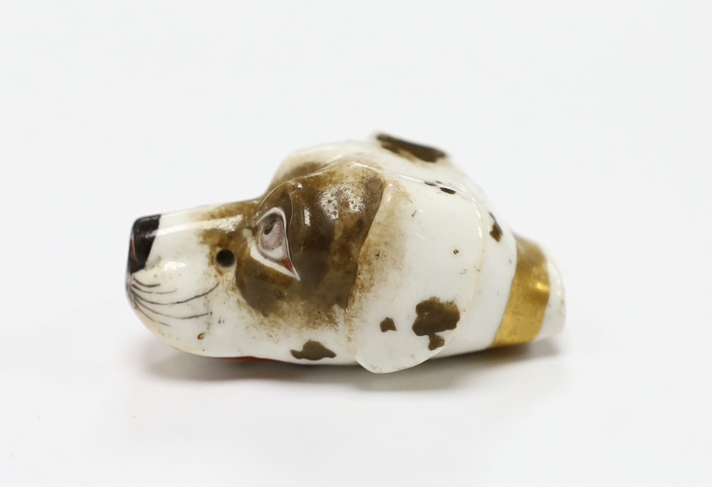 An early 19th century Staffordshire porcelain dog’s head whistle, 4.5cm